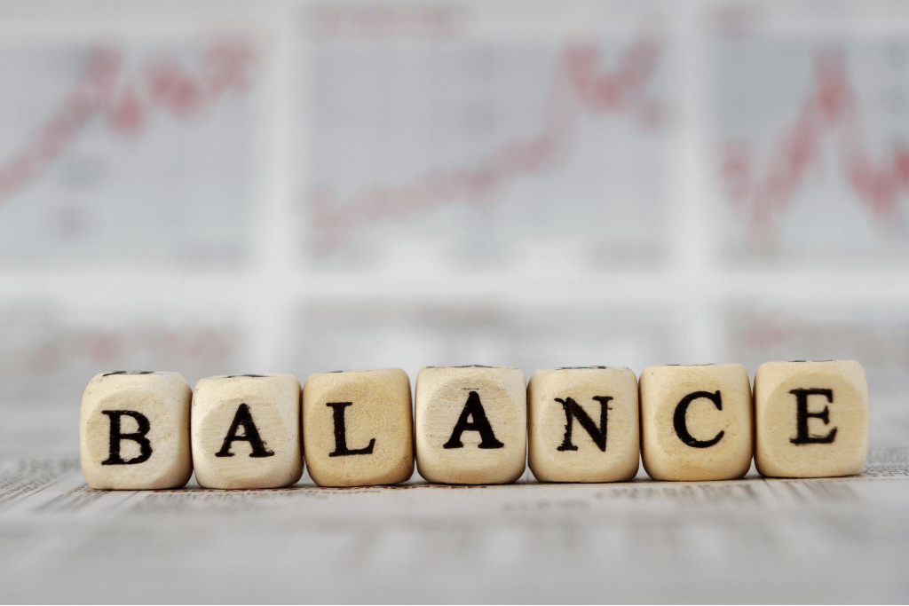 Balance word built with letter cubes on newspaper background